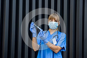 Young nurse holding vials medication and injection needle. Medical doctor picking up medication into syringe