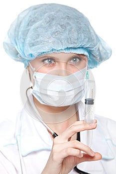 Young nurse in mask with syringe.