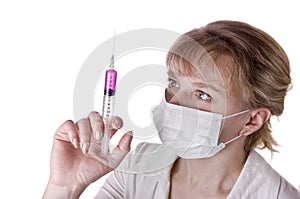 Young nurse in mask with syringe