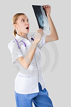 Young nurse studying the X-ray