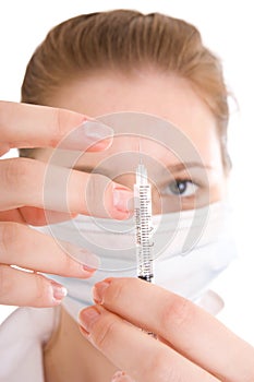 The young nurse with a syringe isolated