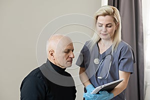 Young nurse taking care of old sick man