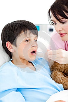 Young nurse taking her patient's temperature