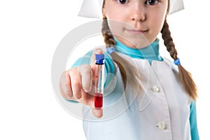 Young nurse with test tubes, red vaccine, closeup