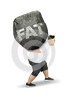 Young obese man carrying fat word on studio