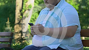 Young obese man looking for friends in network, insecure about body weight