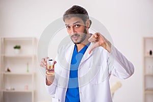 Young male odontologist working in the clinic photo