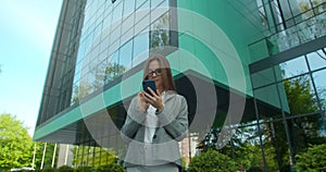 Young office Manager texting Messages. Portrait of attractive Woman using Smartphone. People. Social Network. Apps