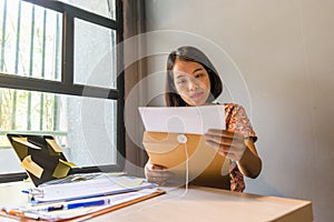 Young office woman reading financial document report