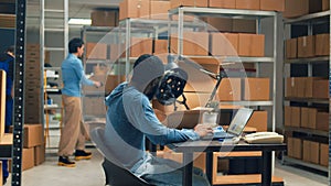 Young office worker checking goods in cardboard packages