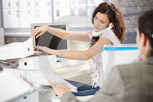 Young office worker on phone busy