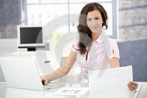 Young office worker smiling in bright office