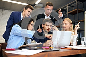 Young office workers correcting the document