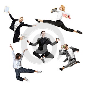 Young office workers jumping and dancing in busness style clothes or suit with folders and gadgets on white background