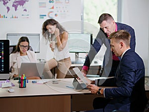 Young office workers work in their office on a new project.