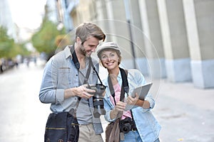 Young ohotographers doing a reportage in town