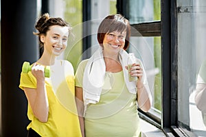 Young and older woman exercising indoors