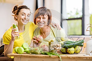 Young and older women with healthy food indoors