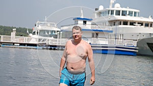 A young oligarch swims in sea against the background