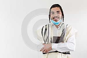 Young Orthodox Jew smiling and wearing a protective mask