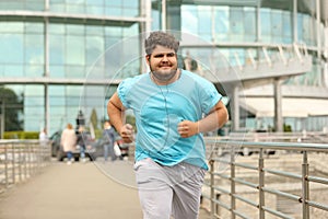 Young overweight man running. Fitness lifestyle