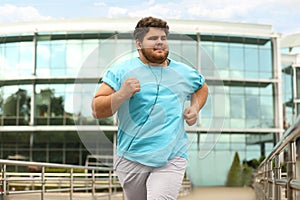 Young overweight man running. Fitness lifestyle photo