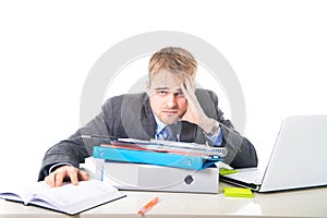 Young overworked and overwhelmed businessman in stress leaning on office folder exhausted and depressed