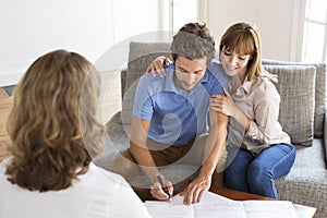 Young owners couple meeting realtor for apartment investment.