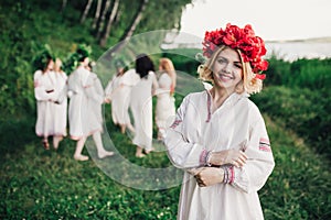 Young pagan Slavic girl conduct ceremony on Midsummer photo