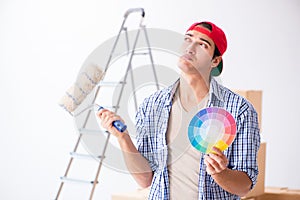 The young painter contractor choosing colors for home renovation