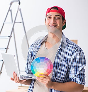 Young painter contractor choosing colors for home renovation