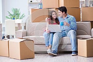 The young pair moving in to new house with boxes