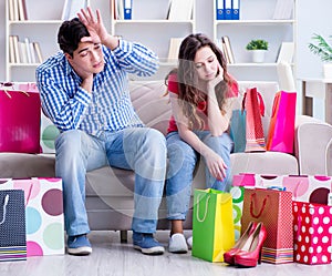 Young pair after shopping with many bags