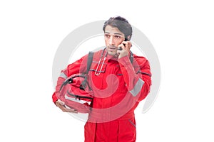 The young paramedic in red uniform isolated on white