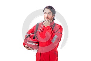 The young paramedic in red uniform isolated on white