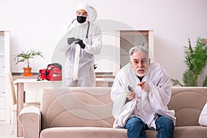 Young paramedic visiting old man at home