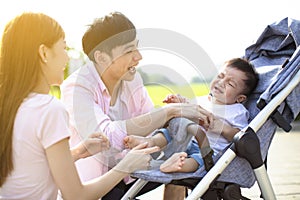 Young parents with baby crying in the carriage