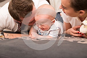 Young parents comfort her crying baby