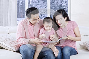 Young parents reading story on book