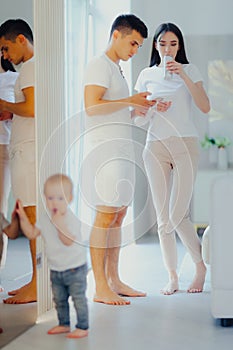 Young parents and small child at home