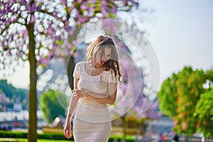 Young Parisian woman near the Eiffel tower in Paris