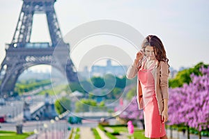 Young Parisian woman near the Eiffel tower in Paris