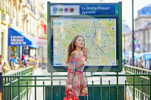 Young Parisian woman near the subway plan