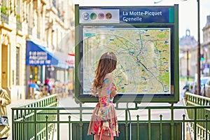 Young Parisian woman near the subway plan