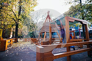 Young parkour guy doing tricks, flips and exercising at a playground