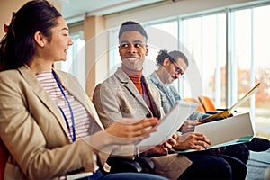 Young participants are chatting during a business lecture in the conference room. Business, people, company