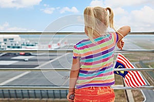 Young passenger looks at planes in airport