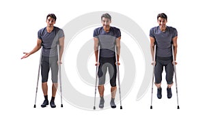 The young patient athlete sportsman suffering an injury trauma with crutches isolated on white