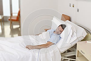 Young patient man lying at hospital bed resting and sleeping having serious medical condition