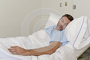 Young patient man lying at hospital bed resting tired looking sad and depressed worried